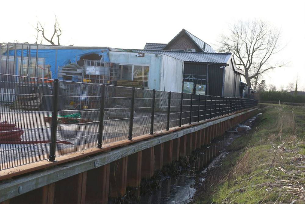 Uitgezette lijn met dubbelstaafmat panelen langs een erfgrens
