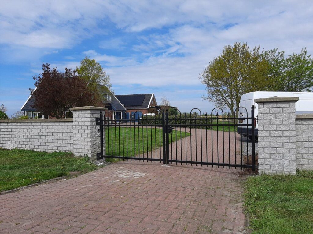 Stalen poort op maat tussen gemetselde poeren