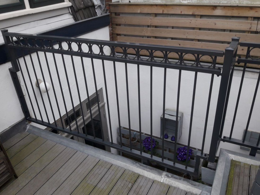 Stalen balustrade langs een galerij van een flat